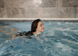 Smiling woman in cold plunge | Ice baths benefits
